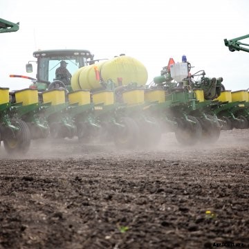 A John Deere tractor and planter working in an Iowa field
