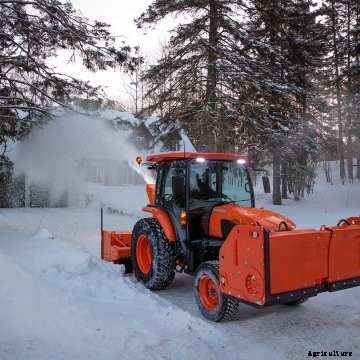 A Kubota compact tractor drives through snow with Nokian Tyres designed for winter conditions