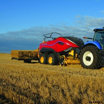 red New Holland BigBaler 340 High Density with a blue New Holland tractor