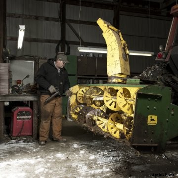 A farmer working in his shop during winter.