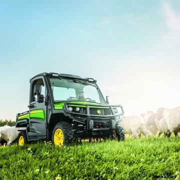 A John Deere Gator in a field.