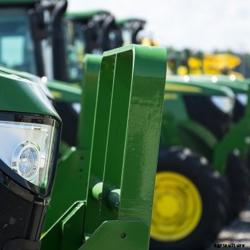 John Deere tractors lined up at an auction.