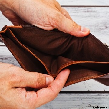 A farmer holding an empty wallet.