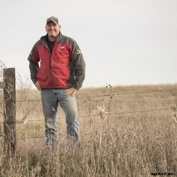 Chad Schooley in a field of grass